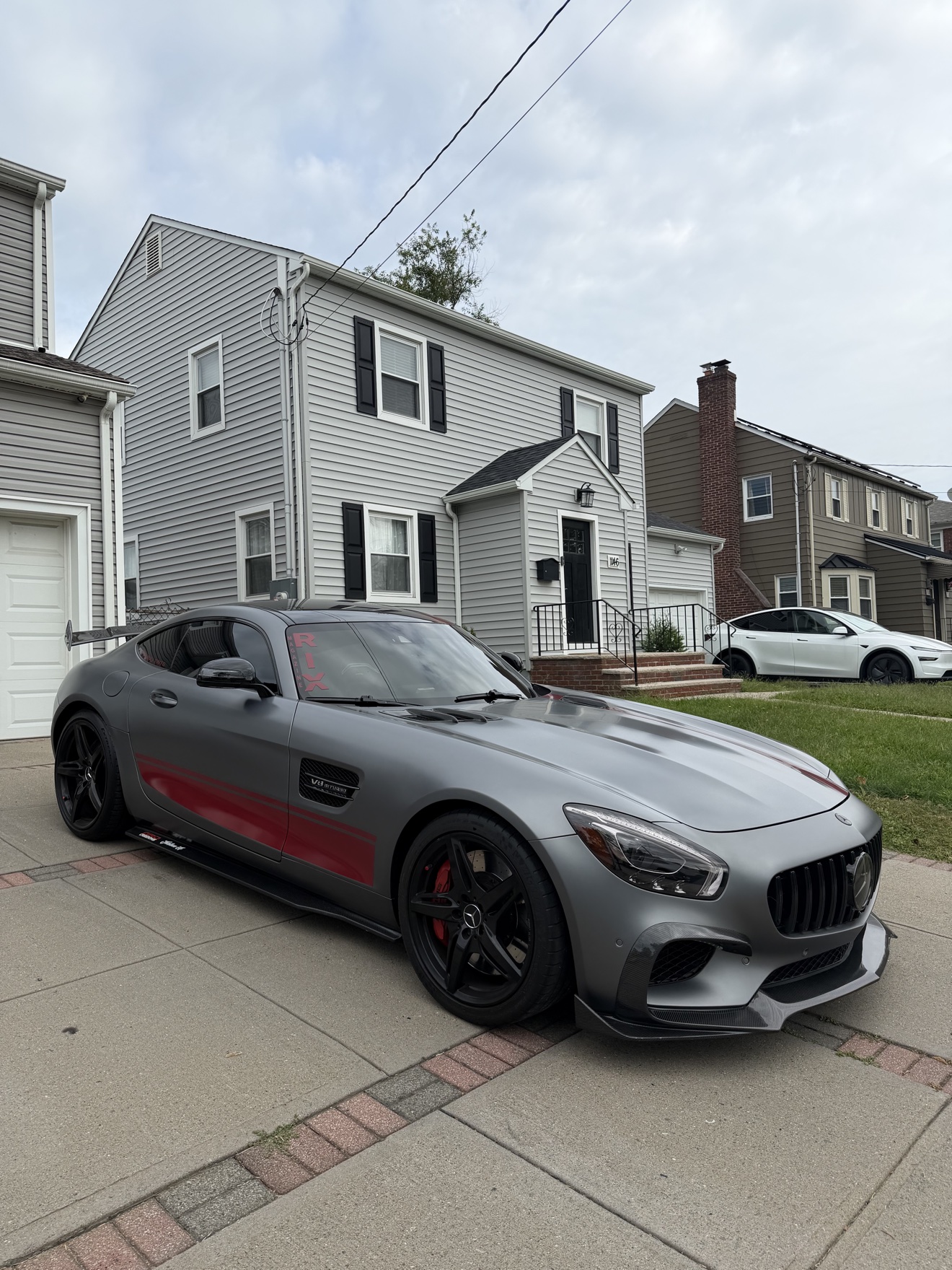 Matte gray Mercedes-AMG GT with a red stripe