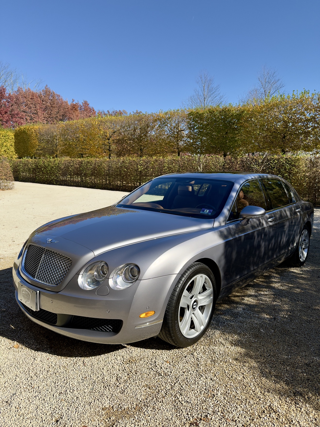 Silver Bentley Continental front three-quarter view after detailing