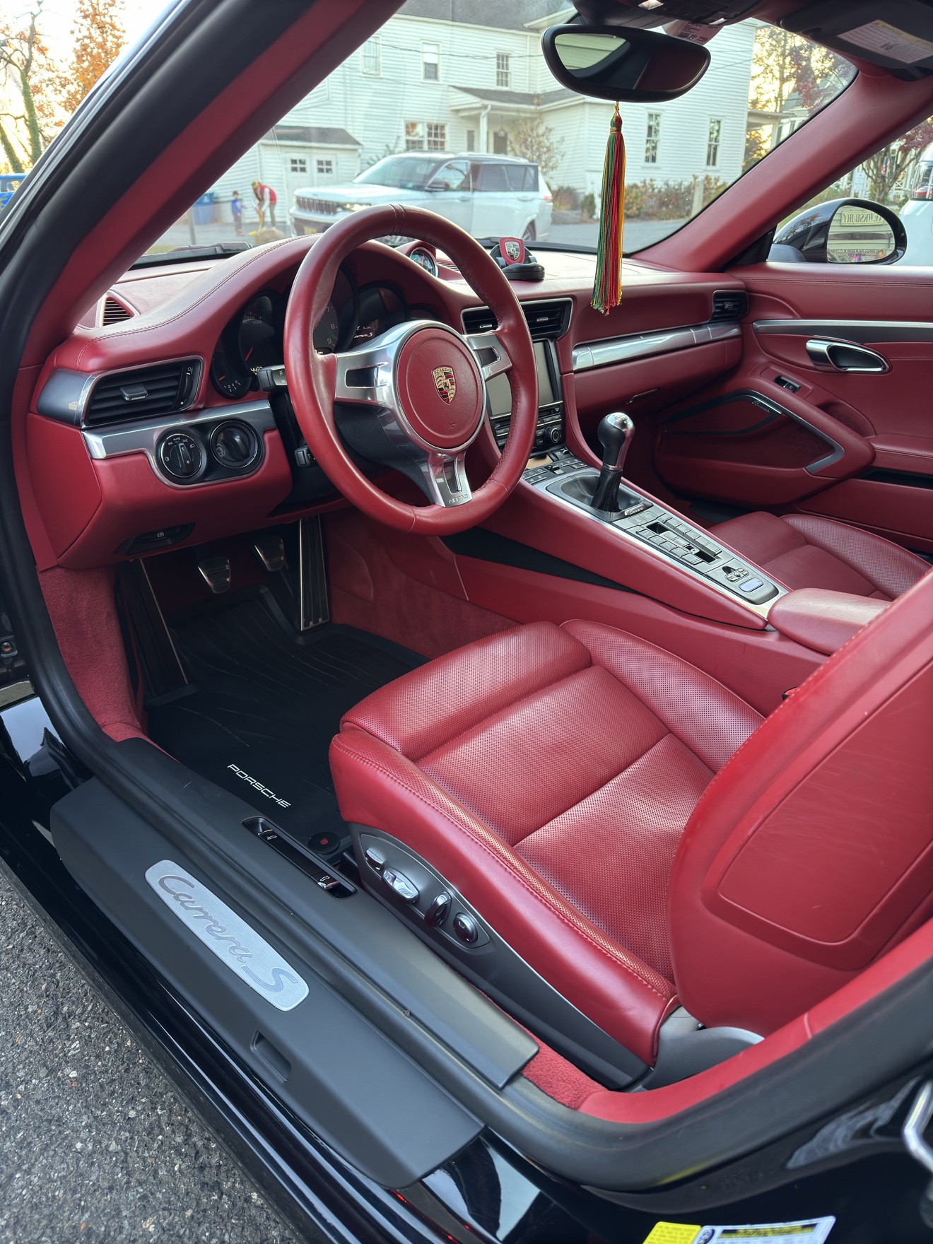 Porsche 911 Carrera S driver interior with red leather and Carrera S sill plate