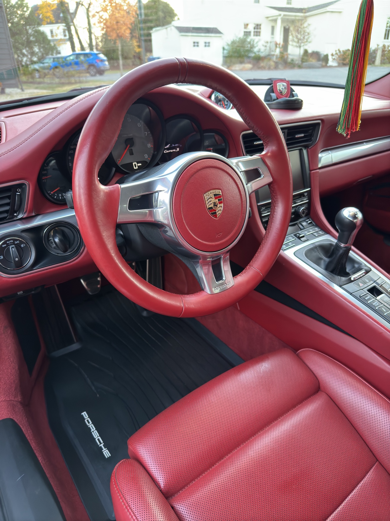 Close-up of the red leather steering wheel in a Porsche 911 Carrera S