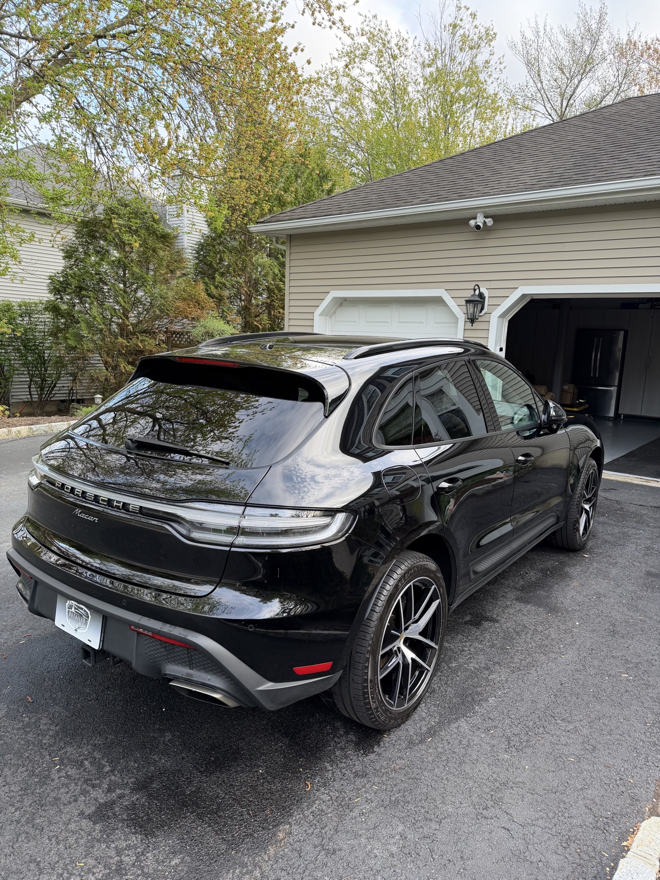 Black Porsche Macan rear three-quarter view after detailing