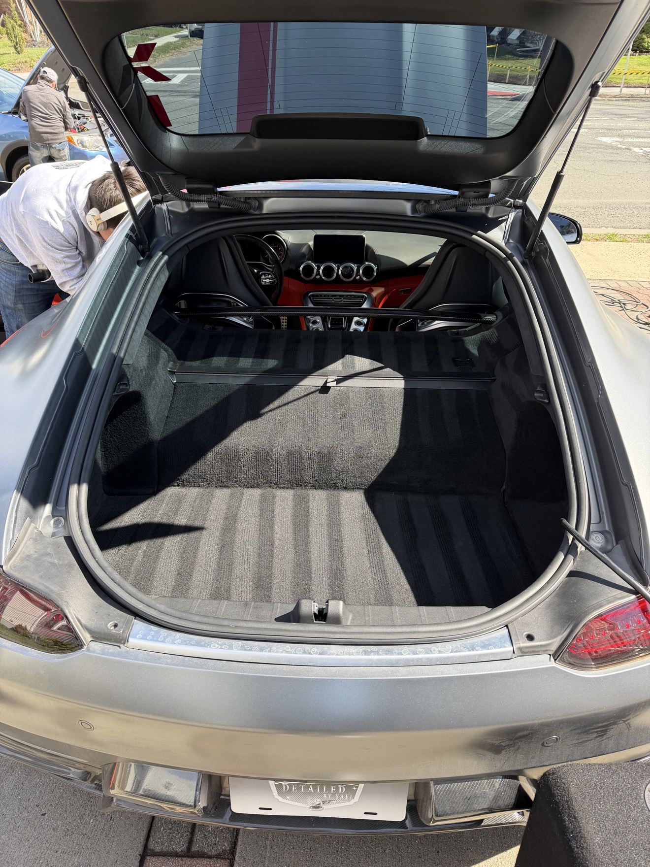 Open trunk of a Mercedes AMG GT with Detailed by Yael plate frame