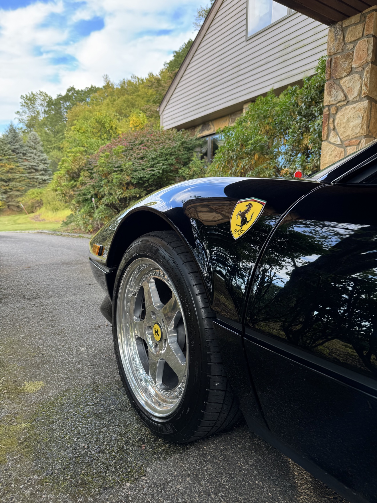 Close-up of the mirror finish on a black Ferrari 308