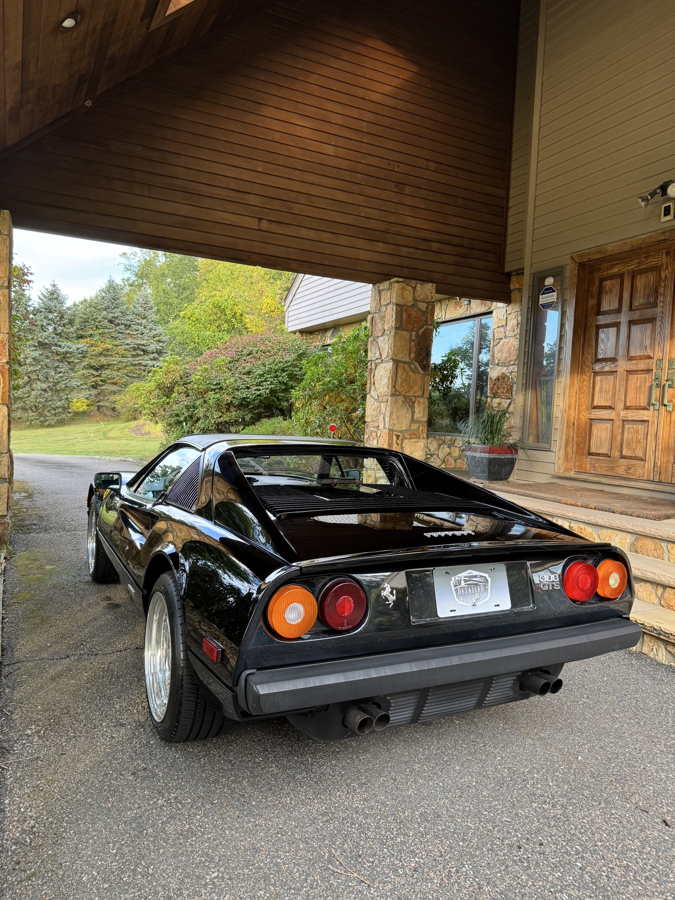 Black Ferrari 308 GTS rear three-quarter view with 308 GTS badge and Detailed by Yael plate frame