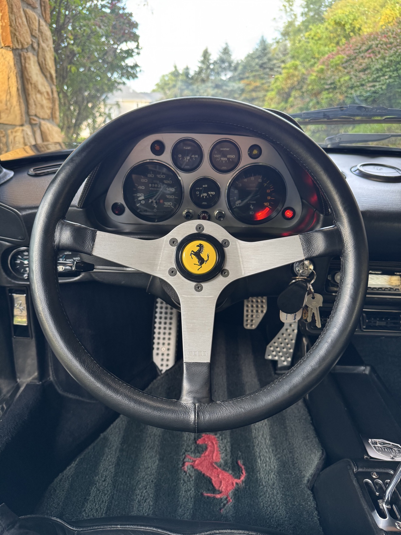Close-up of the steering wheel and gauges in a Ferrari 308 GTS
