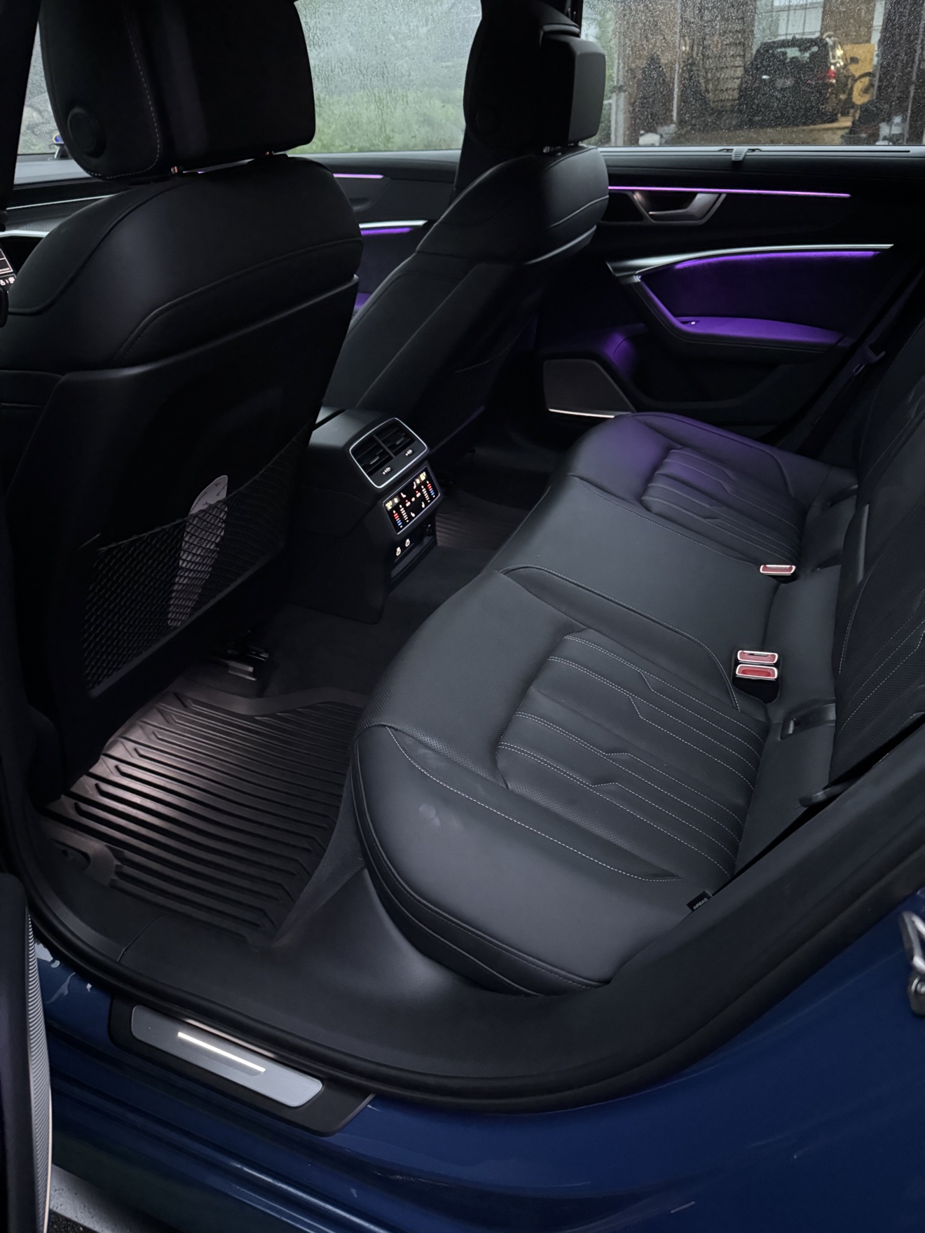 Audi RS6 Avant rear seats in black leather with purple ambient lighting