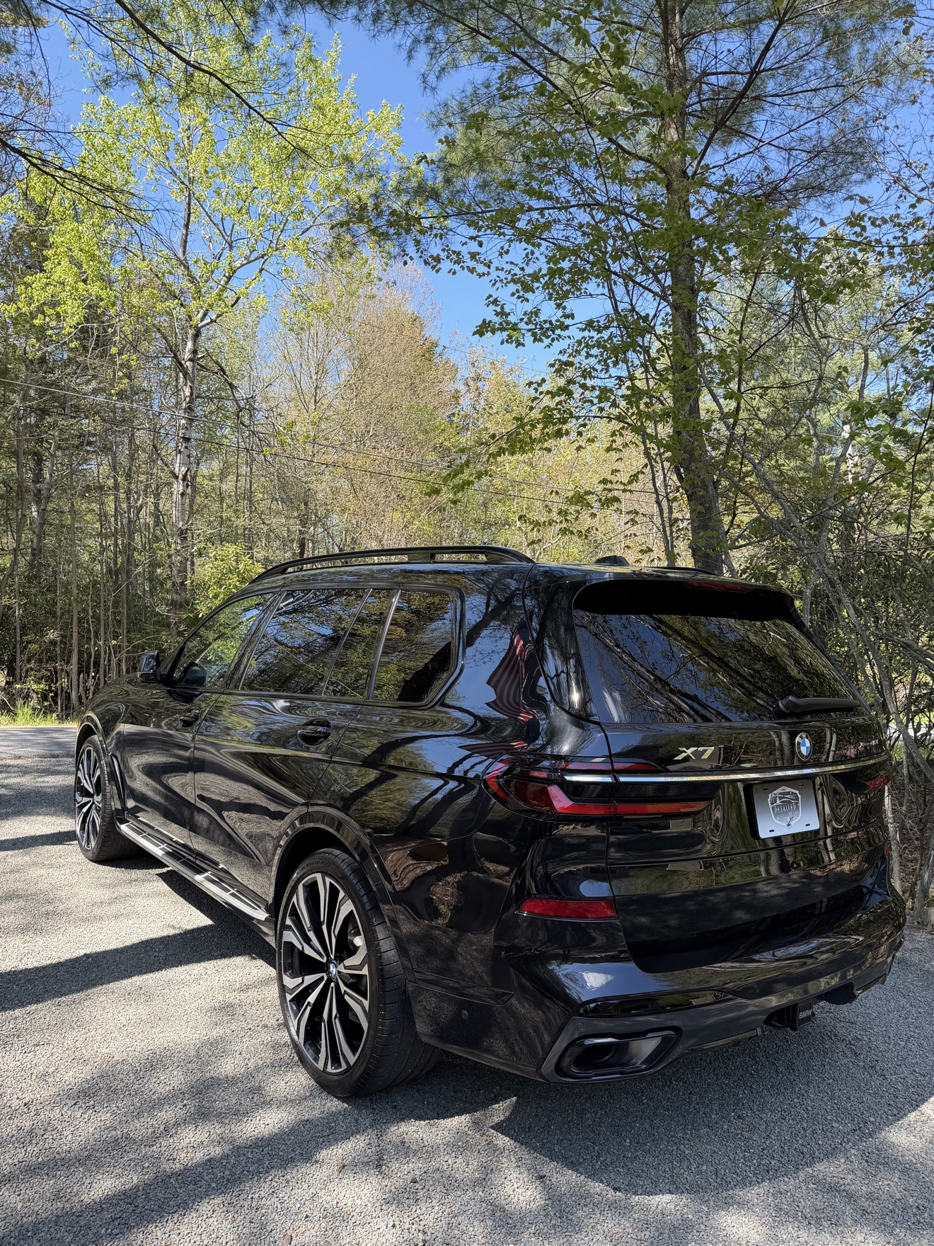 Black BMW X7 rear angle view after detailing