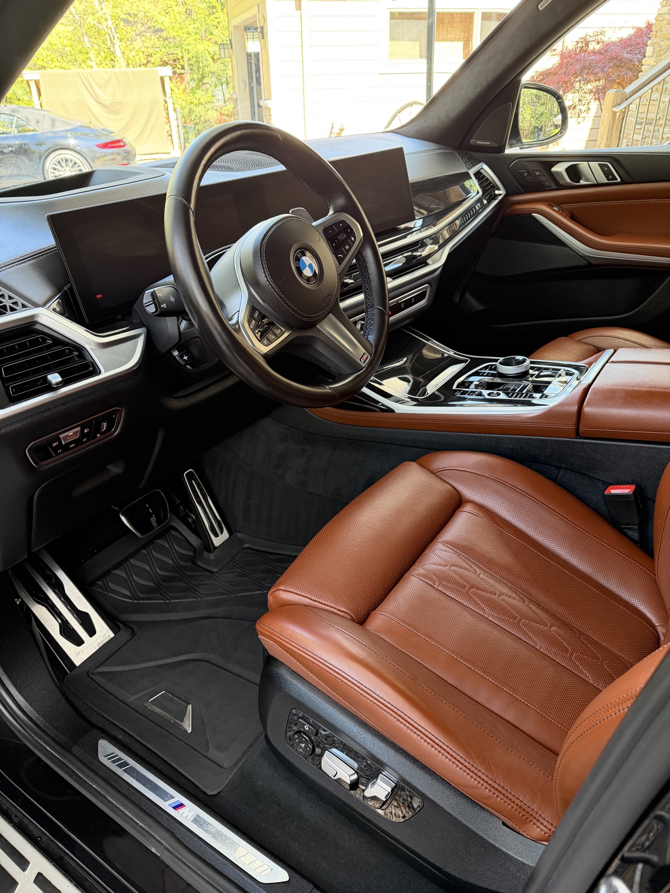 BMW X7 driver cockpit with cognac leather seats after detailing