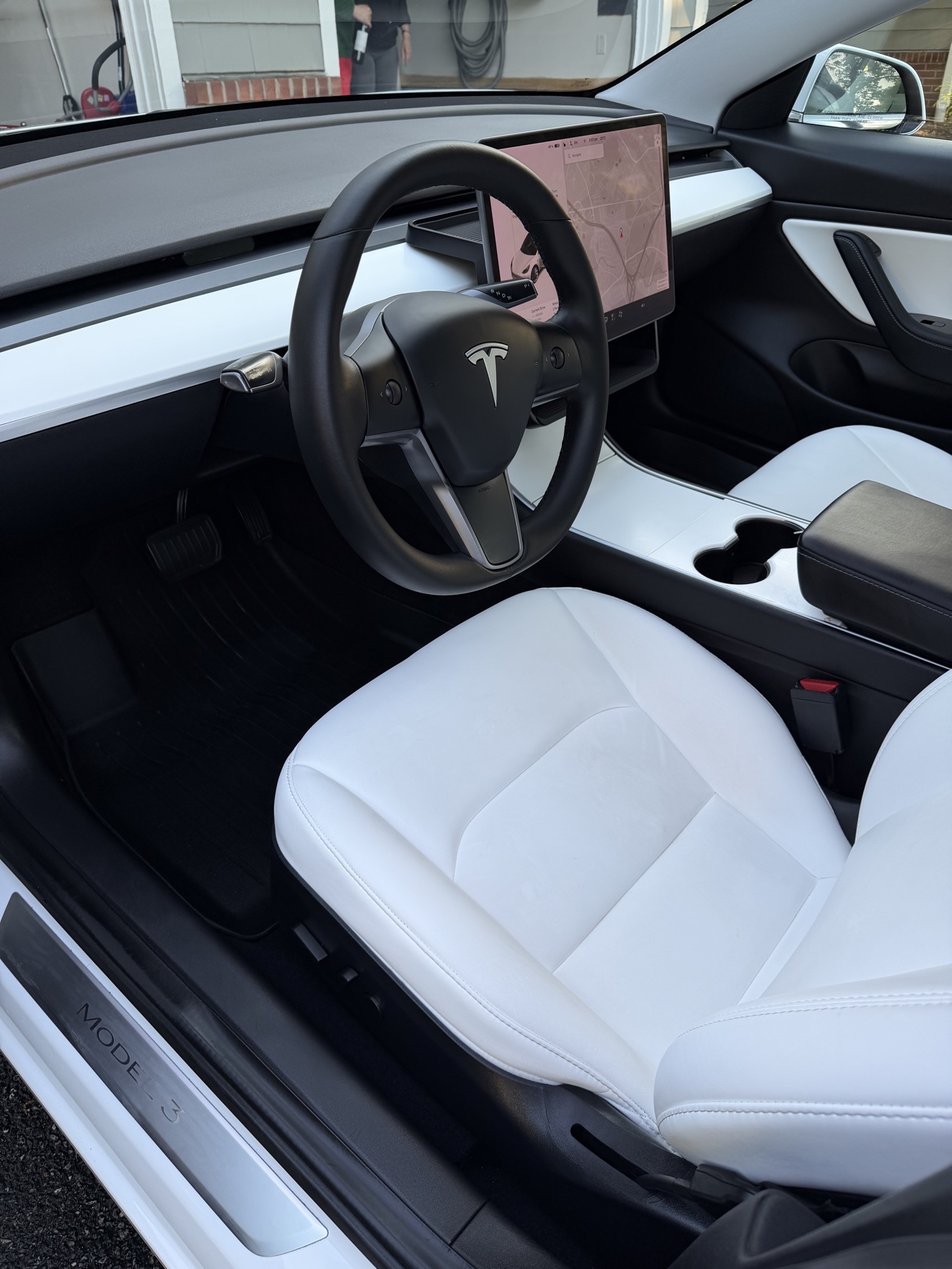 Tesla Model 3 driver cockpit with white seats and Model 3 sill plate