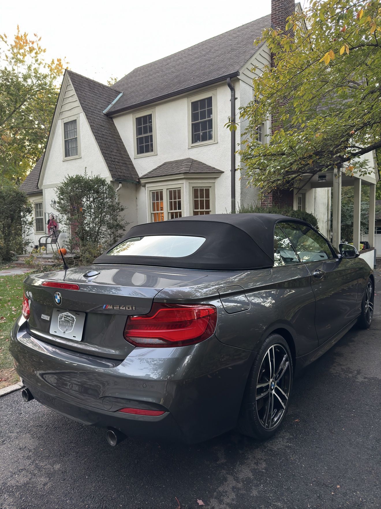 Gray BMW M240i convertible rear three-quarter view with M240i badge