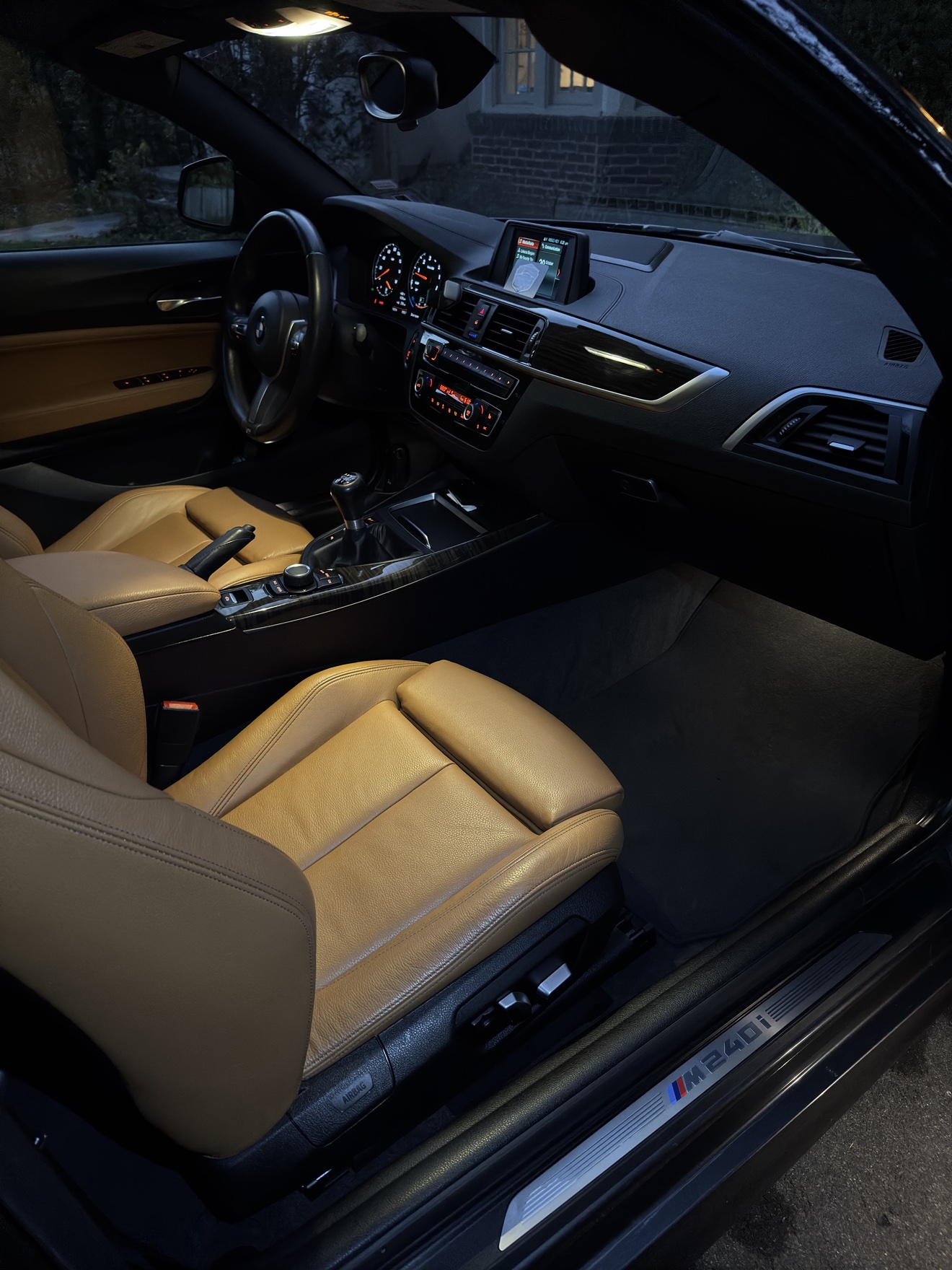 BMW M240i passenger side cockpit with tan leather interior