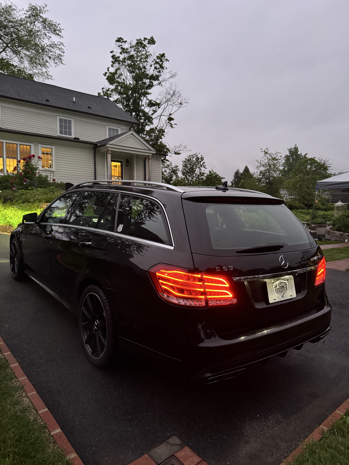 Black Mercedes Benz E63 S AMG wagon rear three-quarter view with E 63 badge