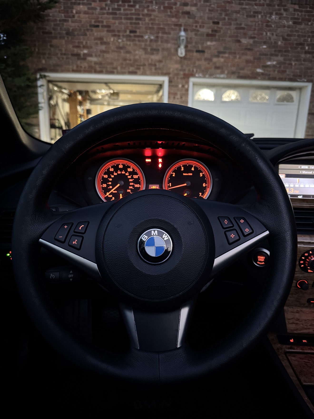 Close-up of the steering wheel and orange gauges in a BMW 650i