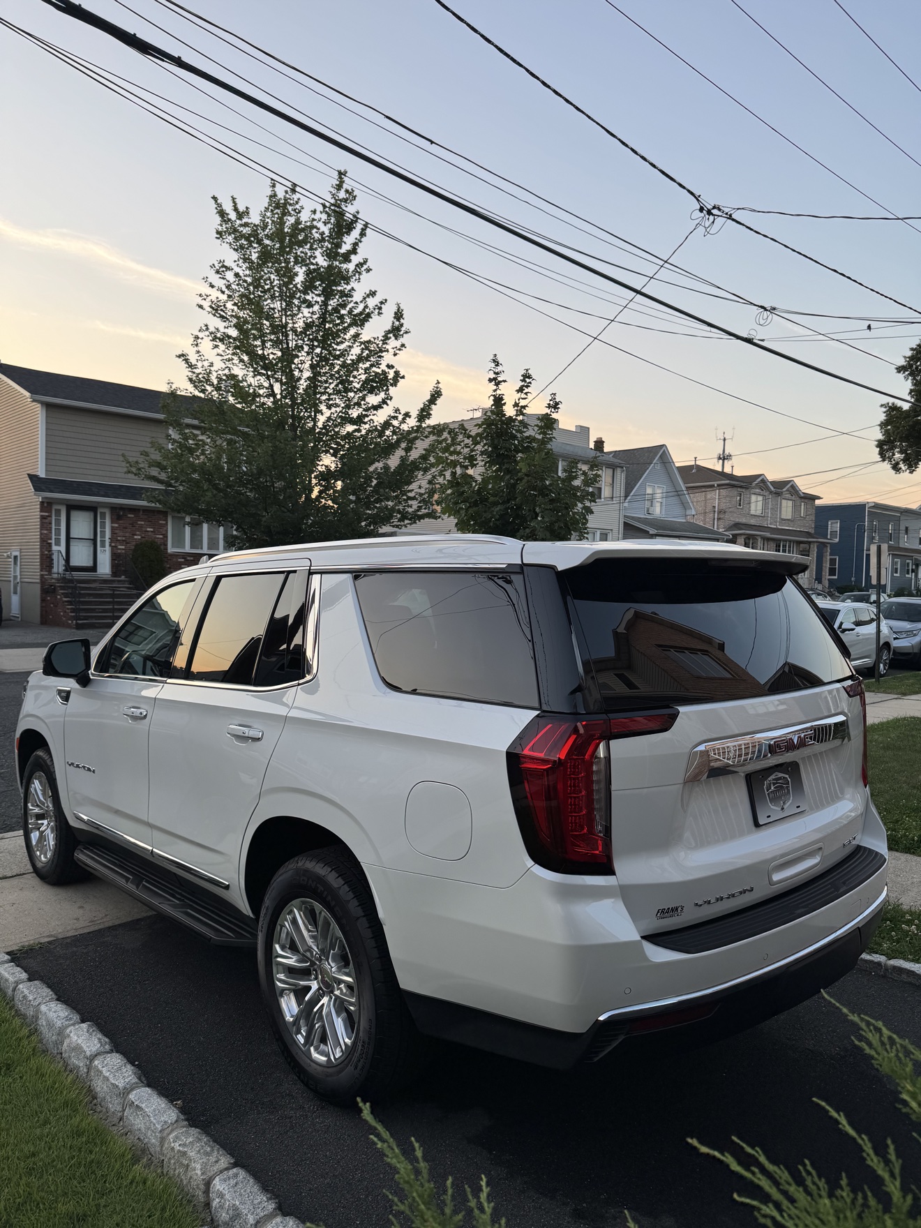 White GMC Yukon SLT rear three-quarter view with SLT badge