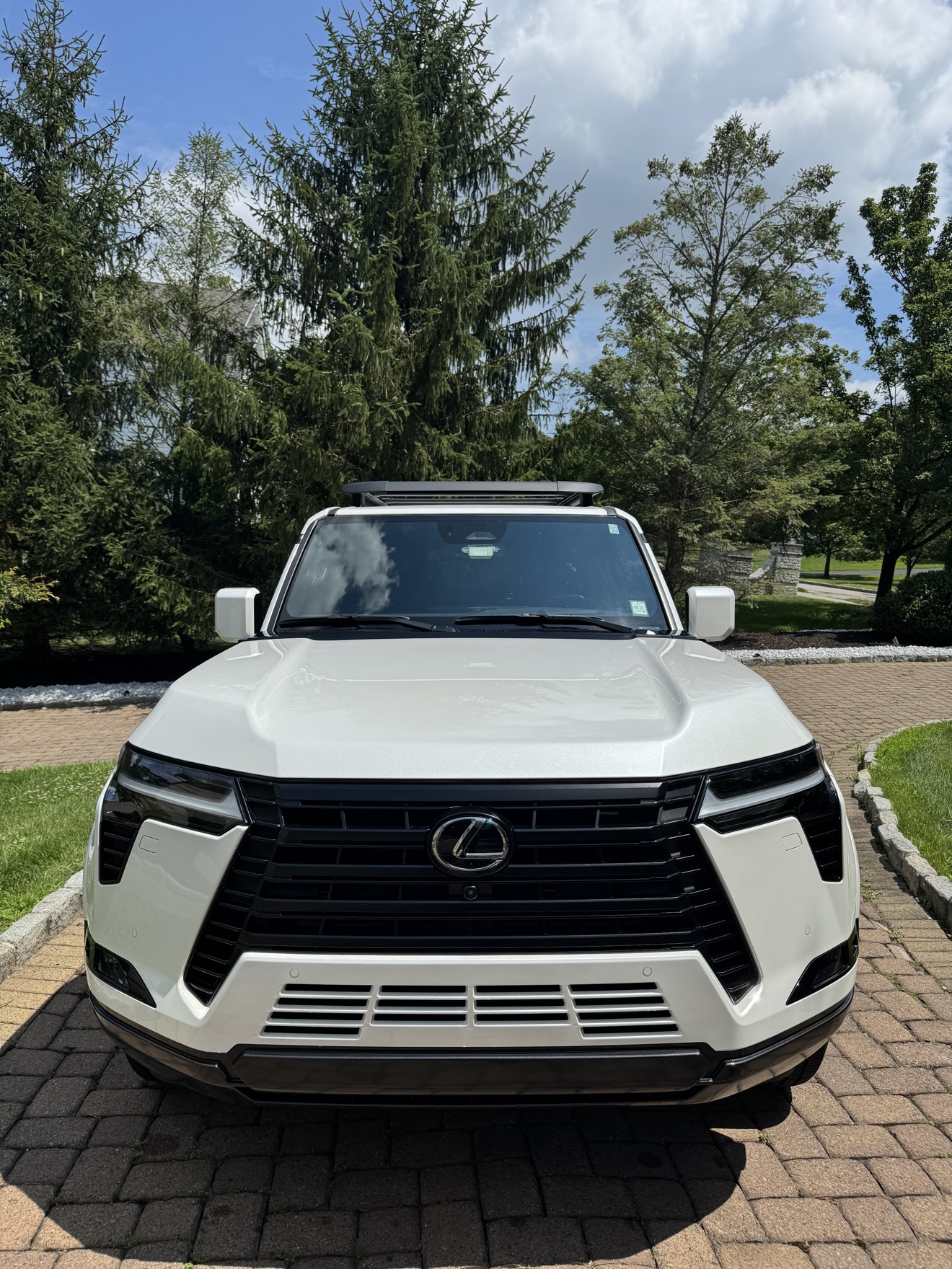Front view of a white Lexus GX550 with spindle grille after detailing