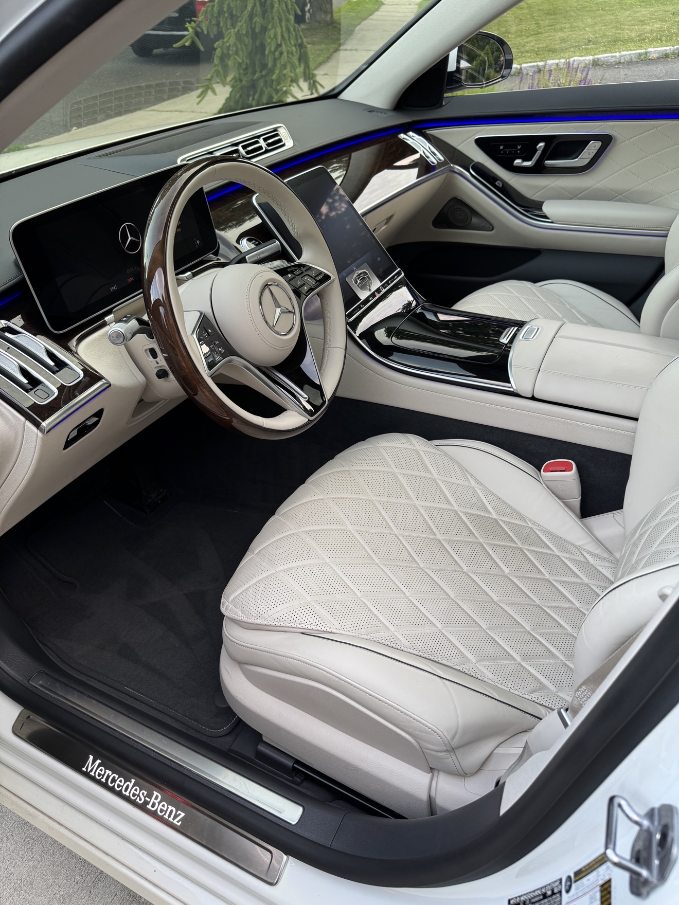 Mercedes-Benz S580 driver cockpit with white quilted leather seats and ambient lighting after detailing