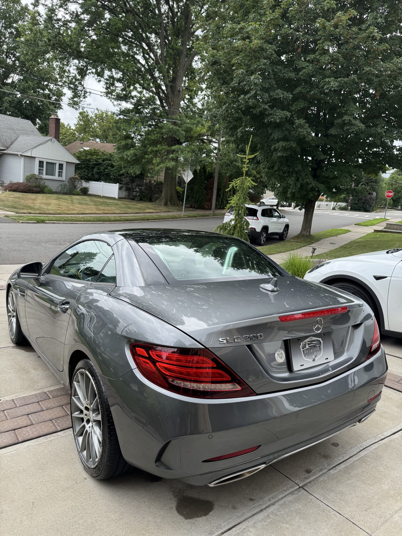 Rear three-quarter view of a gray Mercedes-Benz SLC 300 roadster with SLC 300 badge
