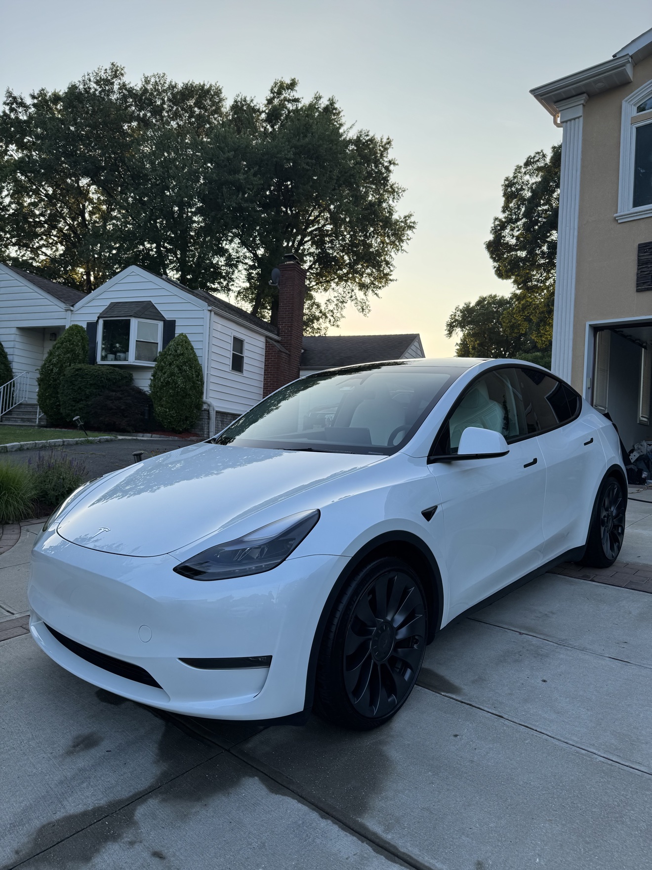 White Tesla Model Y front three-quarter view after detailing