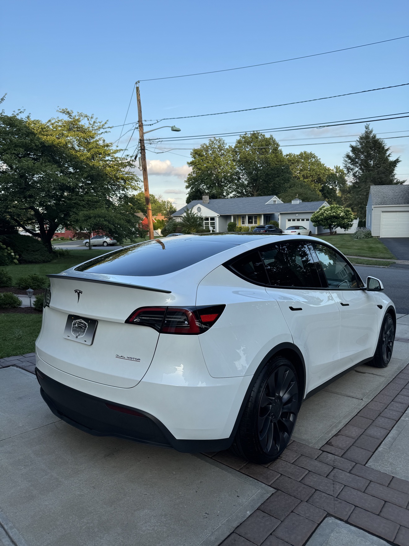 White Tesla Model Y rear angle view after detailing