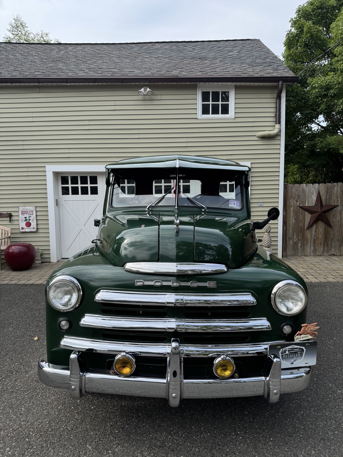 Front view of a green vintage Dodge B-Series “Pilothouse” Pickup with Detailed by Yael plate frame