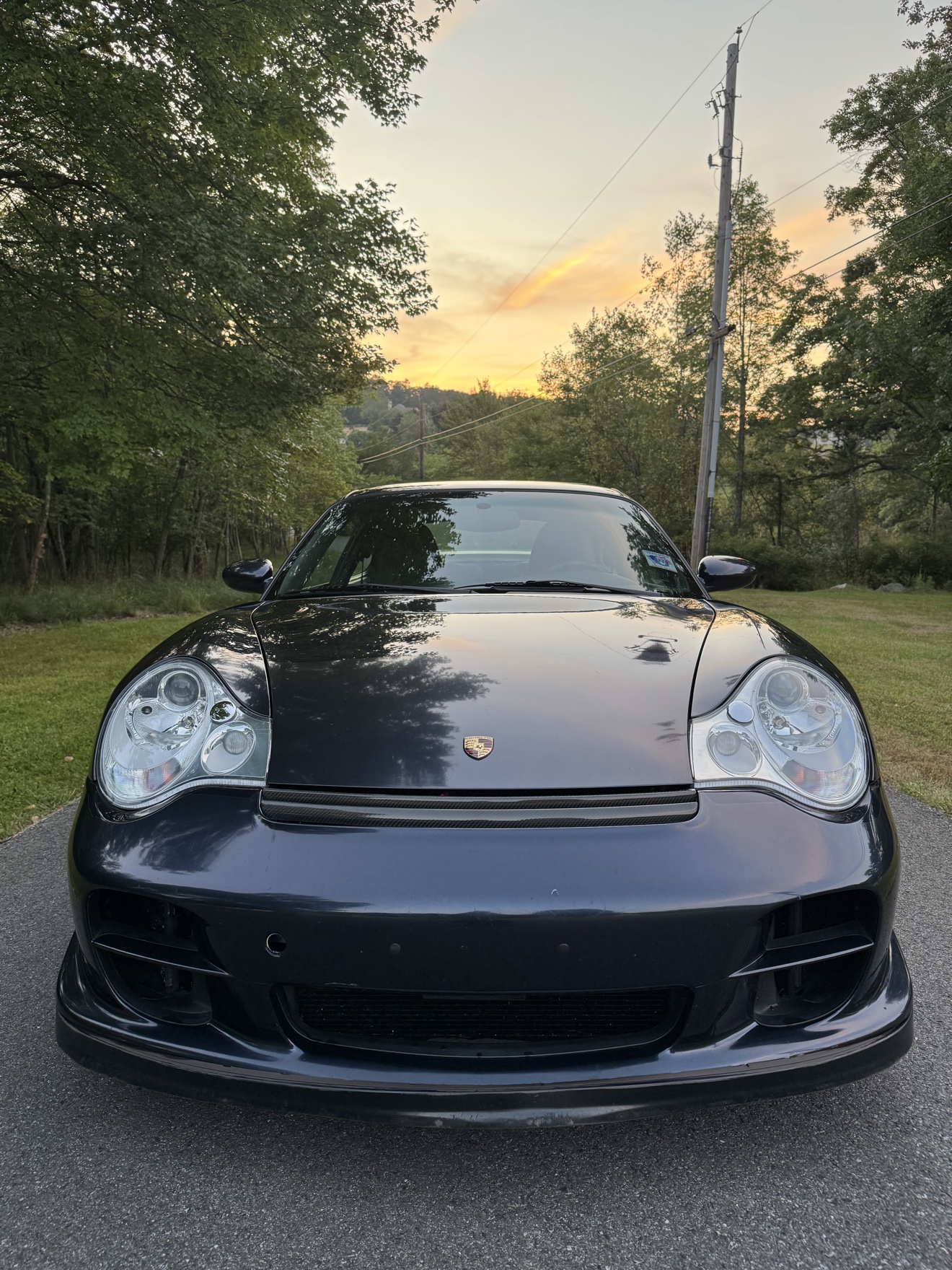 Front view of a black Porsche 911 Turbo with gold BBS wheels