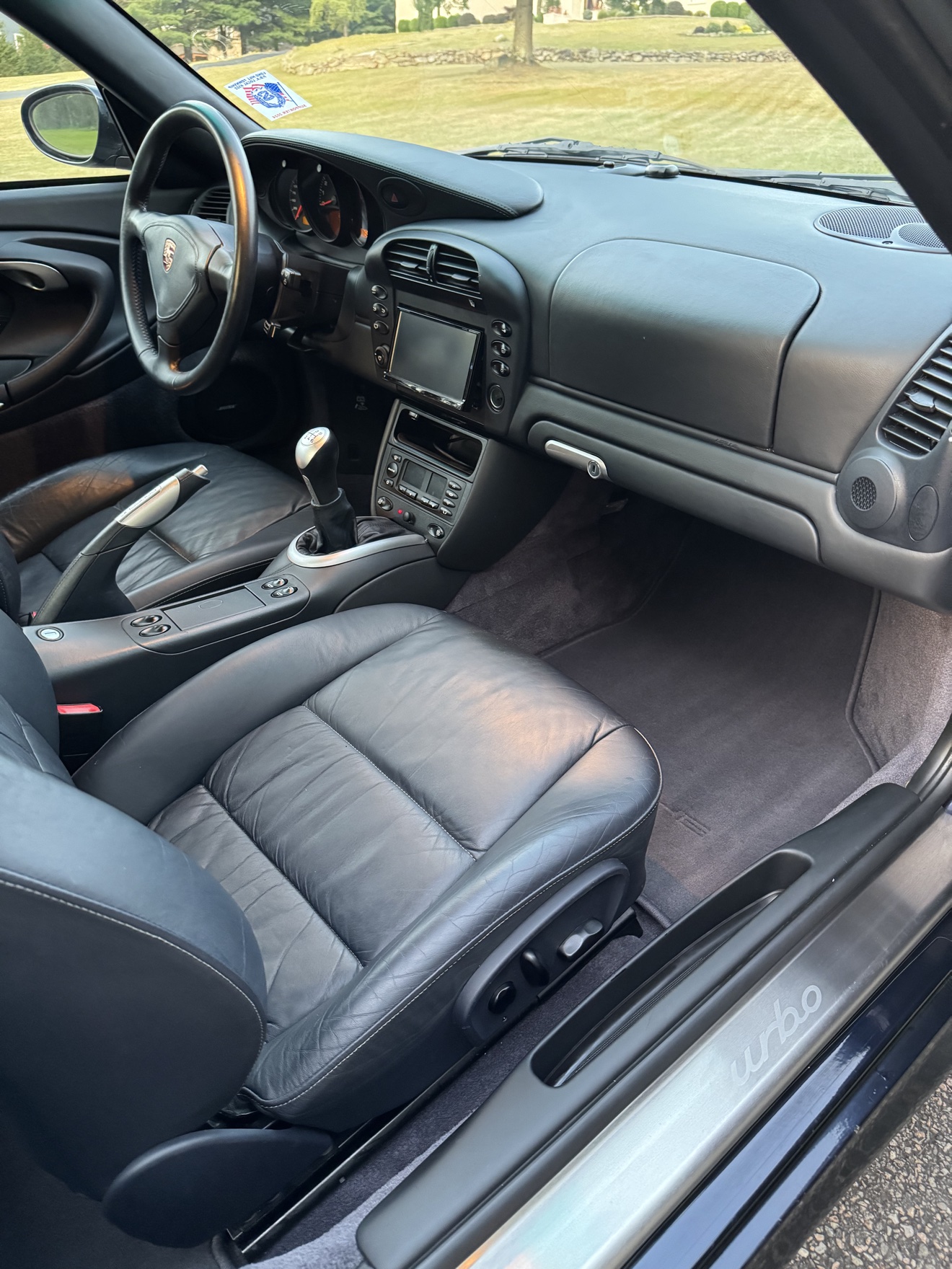 Porsche 911 Turbo passenger side cockpit with black leather seats and turbo sill plate