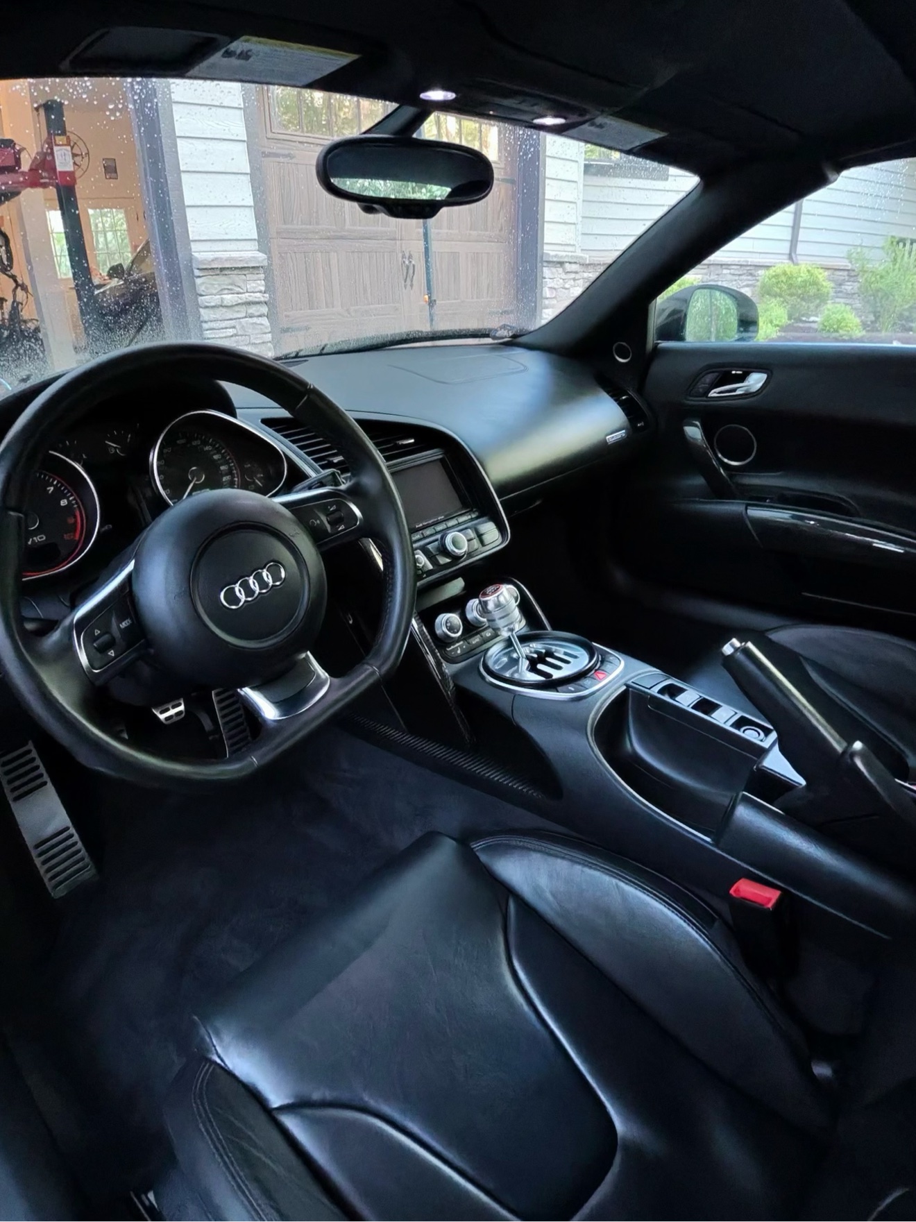 Audi R8 Spyder cockpit with black leather interior and gated manual shifter