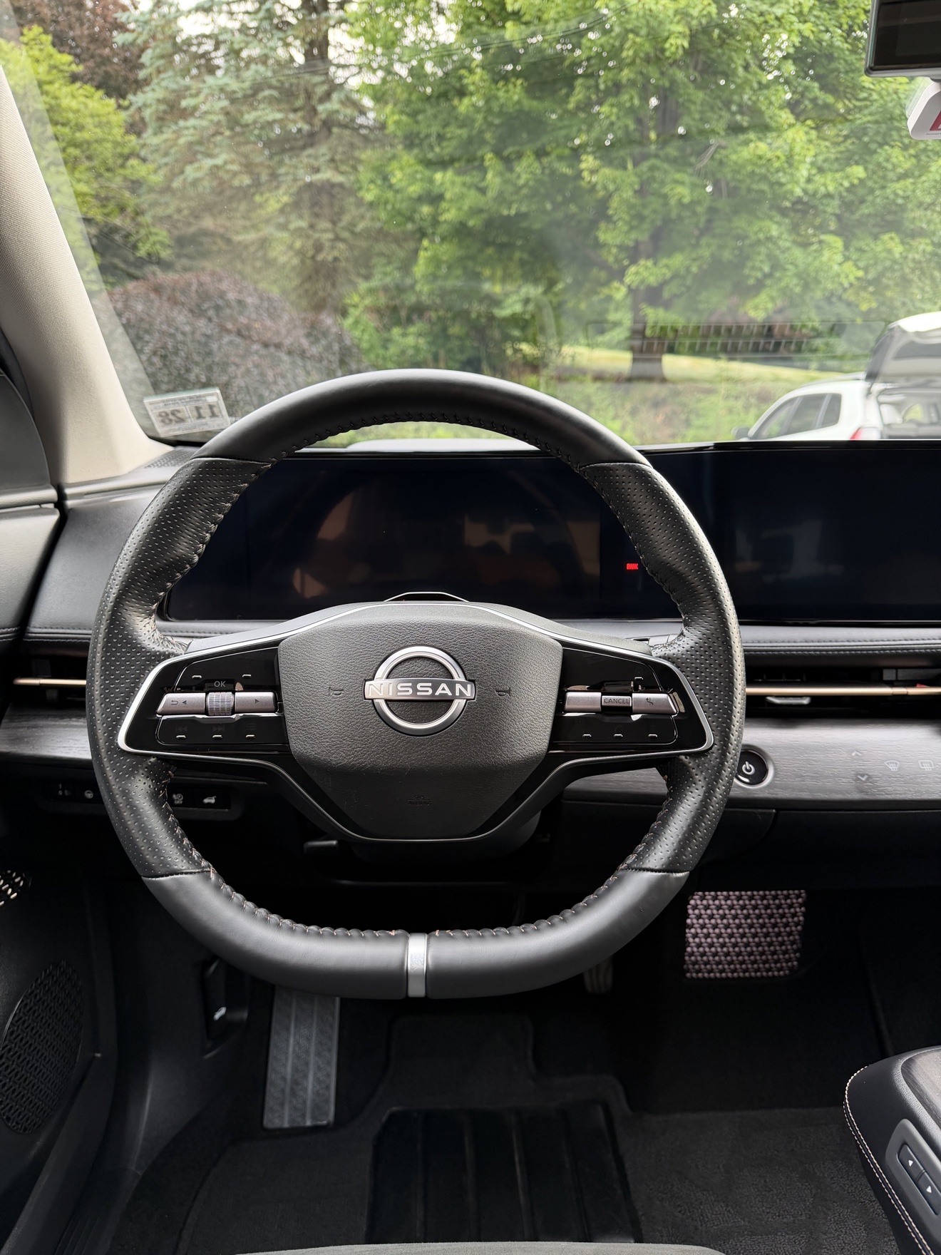 Close-up of the steering wheel and dual displays in a Nissan Ariya