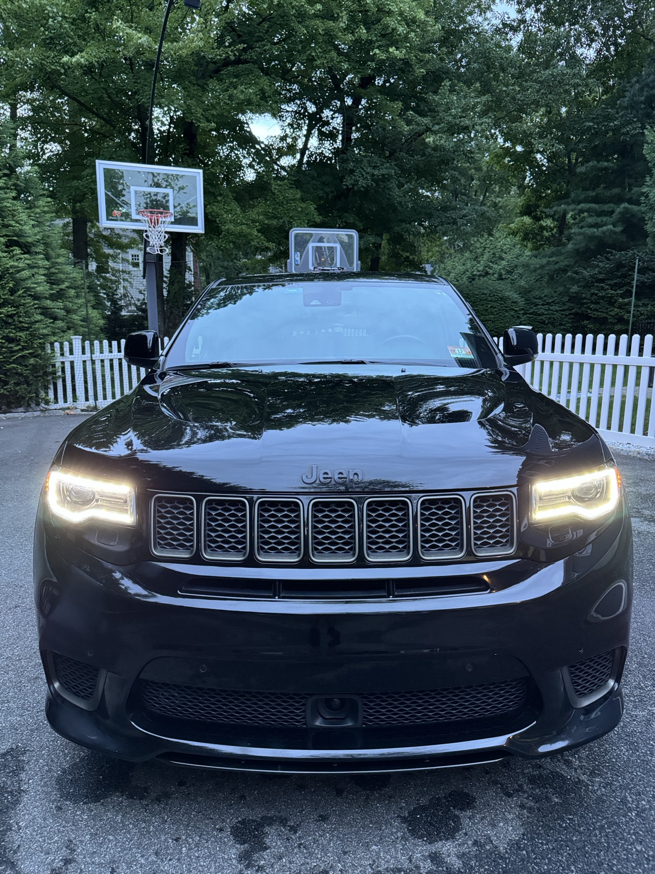 Black Jeep Grand Cherokee Trackhawk front view with headlights on after detailing