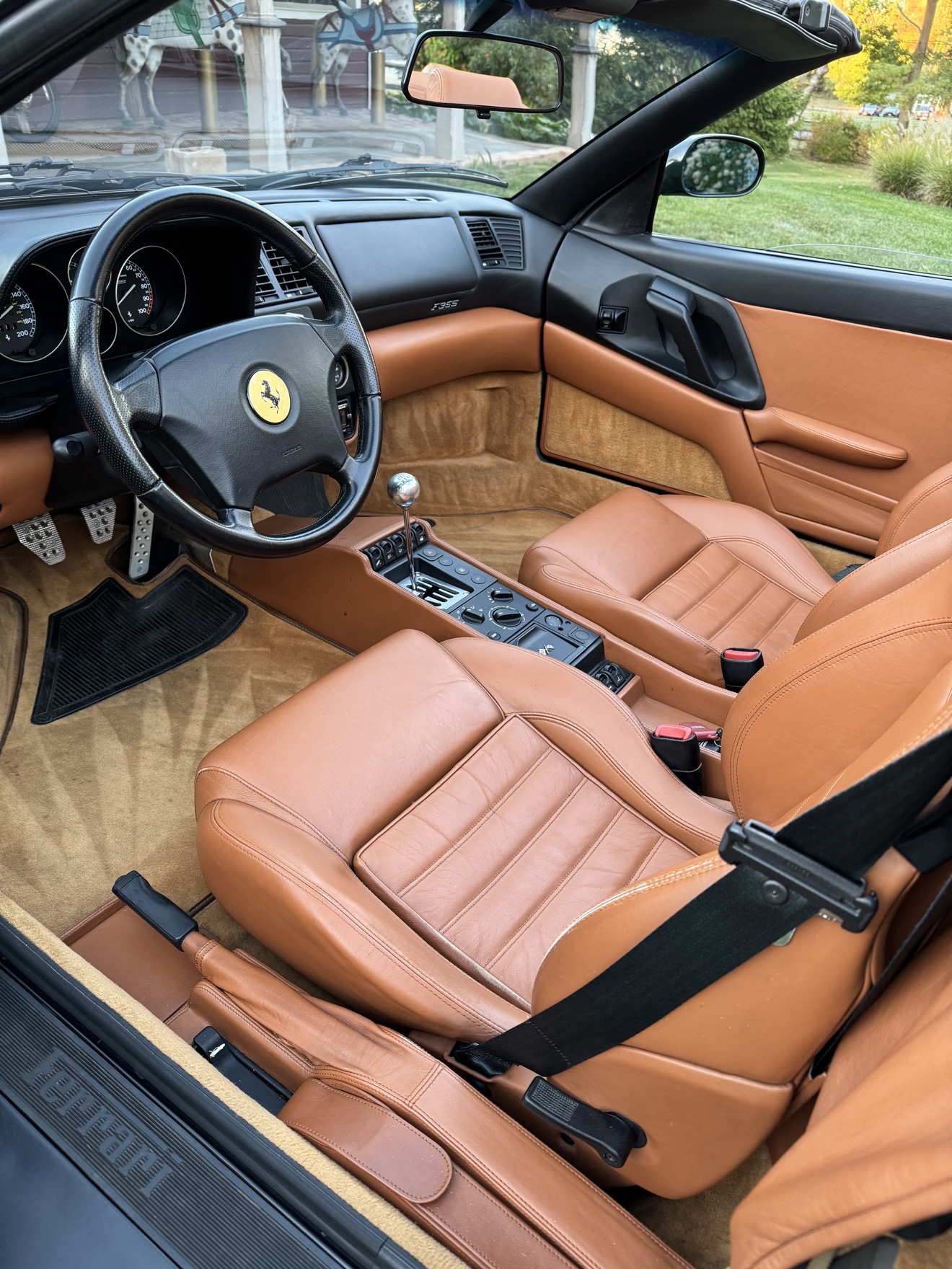 Ferrari F355 Spider driver interior with tan leather seats and gated shifter