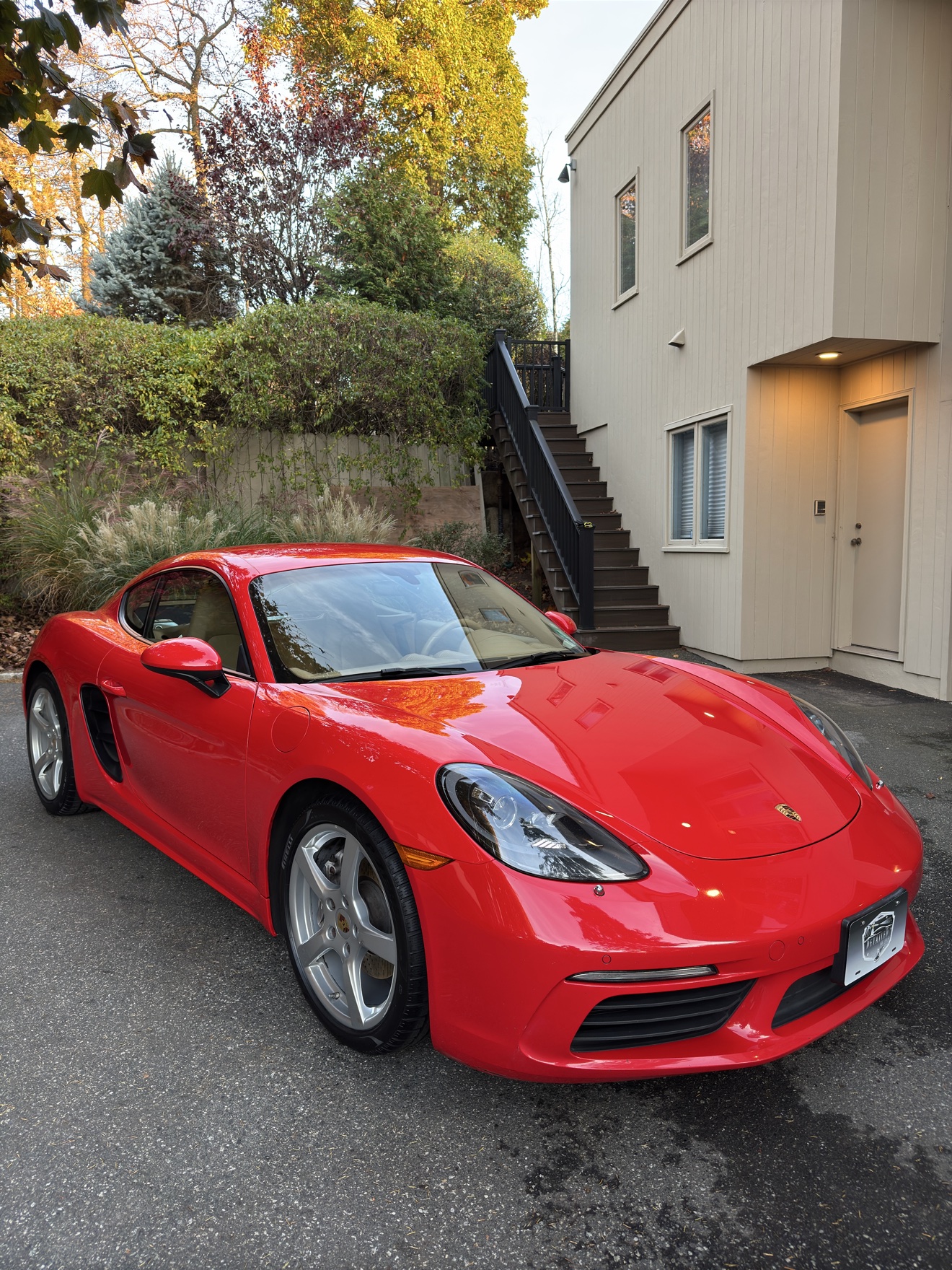 Red Porsche 718 Cayman front three-quarter view after detailing